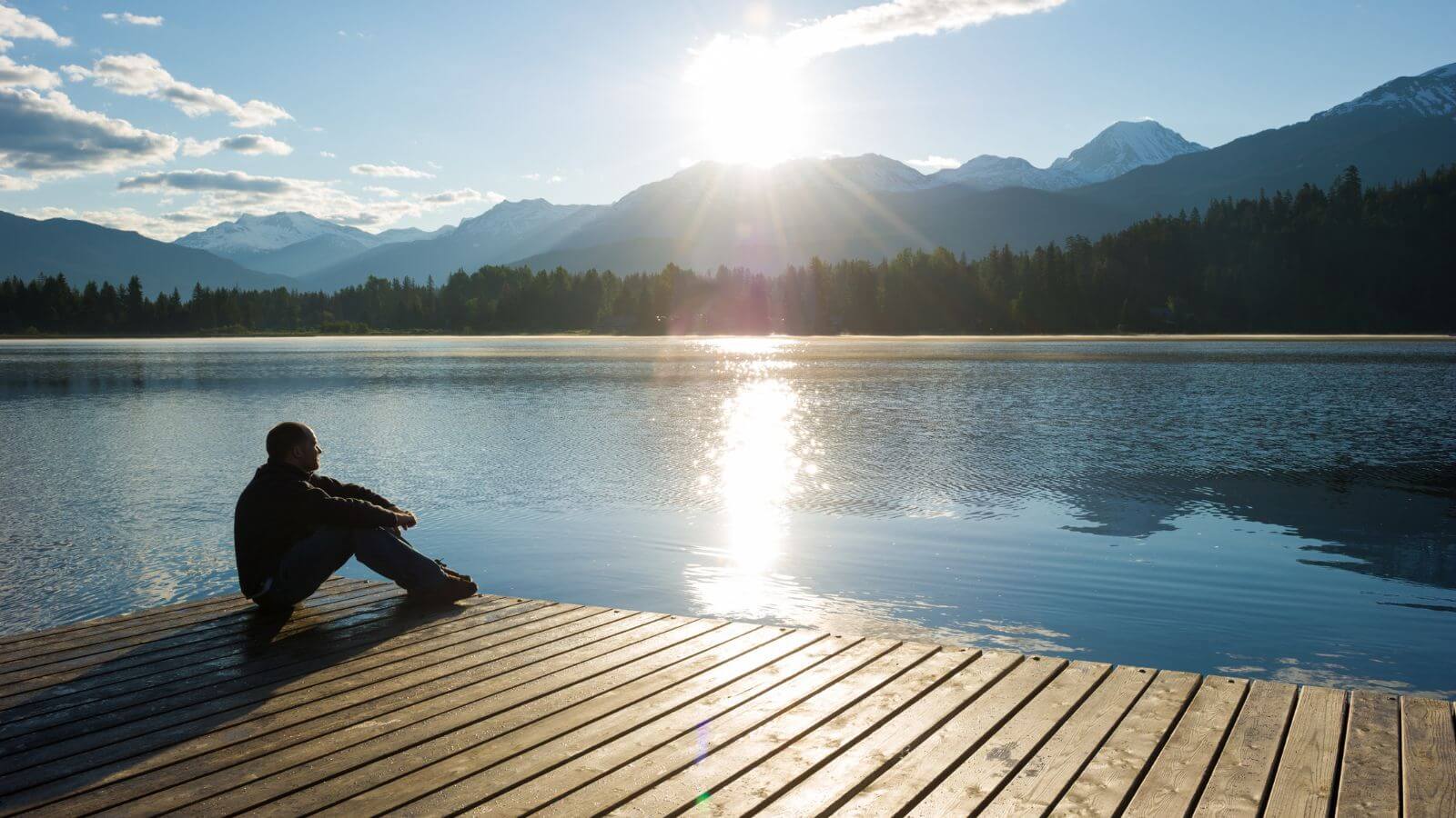 man sitting on dock at lake thinking about making a career transition