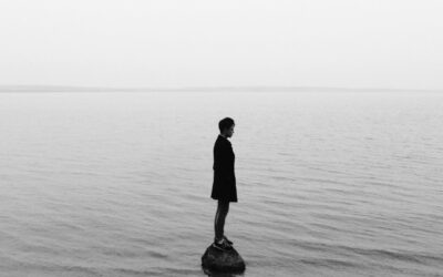 person standing alone on a rock